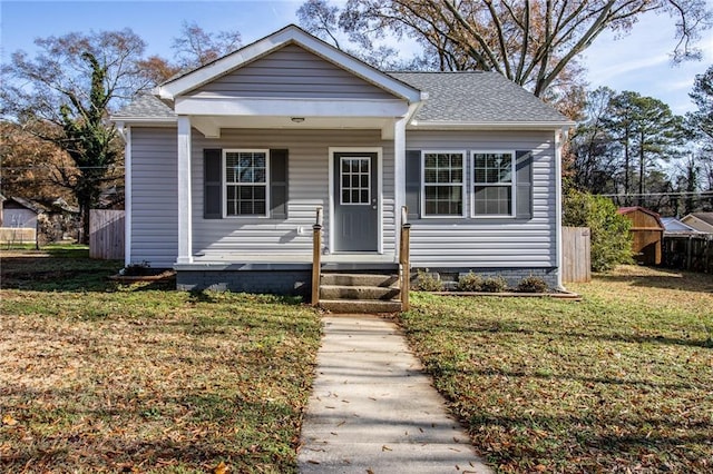 bungalow-style home with a front lawn