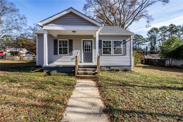 bungalow-style home featuring a front lawn