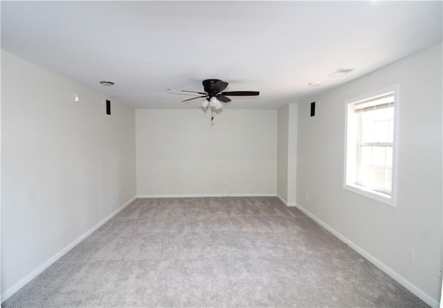 carpeted spare room with ceiling fan