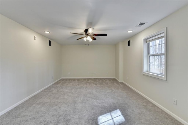 unfurnished room featuring baseboards, visible vents, ceiling fan, and carpet flooring