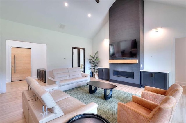 3960 Stock Rd, Monroe, GA 30656 - living area featuring light wood-type flooring, a large fireplace, and high vaulted ceiling