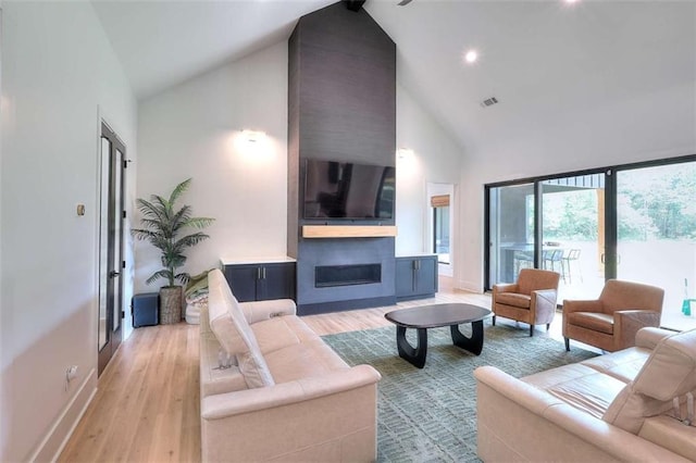 3960 Stock Rd, Monroe, GA 30656 - living room with high vaulted ceiling, light wood finished floors, a fireplace, and recessed lighting