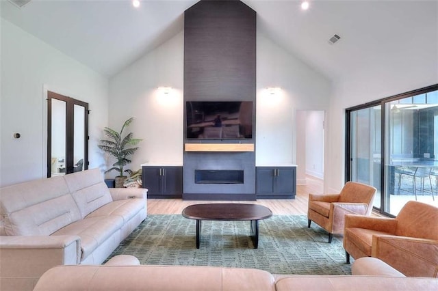 3960 Stock Rd, Monroe, GA 30656 - living room featuring high vaulted ceiling, a large fireplace, wood finished floors, healthy amount of natural light, and recessed lighting