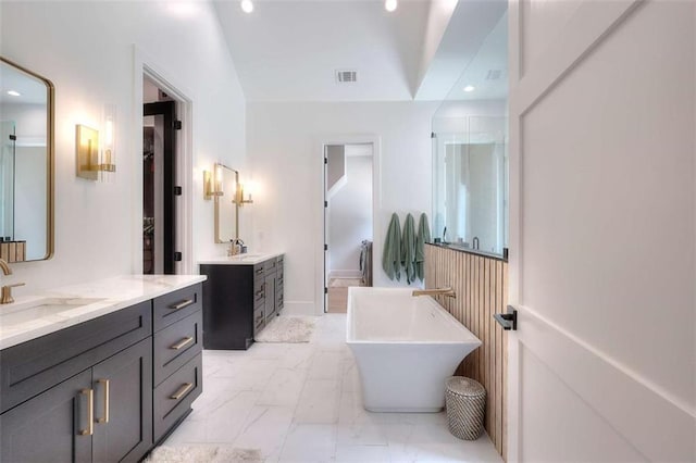 3960 Stock Rd, Monroe, GA 30656 - bathroom with two vanities, a freestanding tub, marble look tile flooring, recessed lighting, and a shower stall