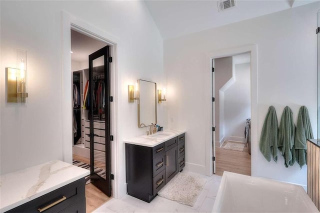 3960 Stock Rd, Monroe, GA 30656 - bathroom with vanity, a bath, and a walk in closet