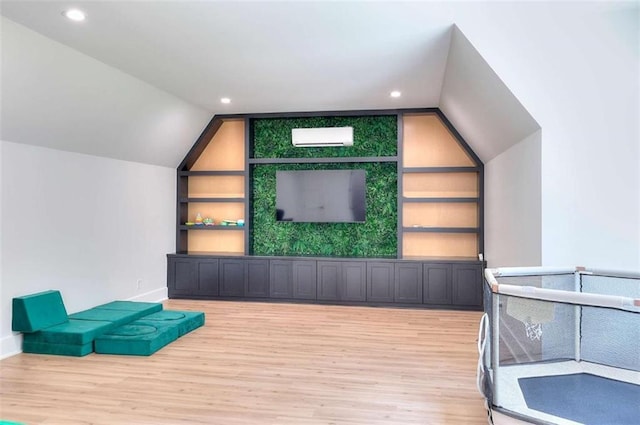 3960 Stock Rd, Monroe, GA 30656 - unfurnished room featuring wood finished floors, a wall mounted air conditioner, lofted ceiling, built in shelves, and recessed lighting