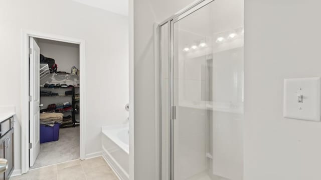 305 Knights Ct, Canton, GA 30115 - full bath featuring a shower stall, vanity, a bath, tile patterned floors, and a walk in closet