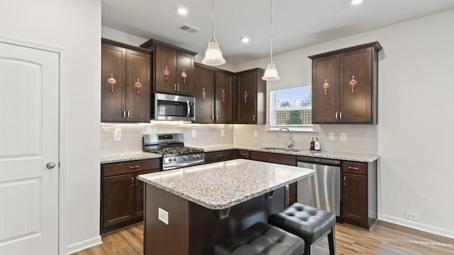 305 Knights Ct, Canton, GA 30115 - kitchen with tasteful backsplash, a breakfast bar area, stainless steel appliances, a sink, and visible vents