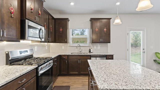 305 Knights Ct, Canton, GA 30115 - kitchen featuring appliances with stainless steel finishes, tasteful backsplash, plenty of natural light, and a sink