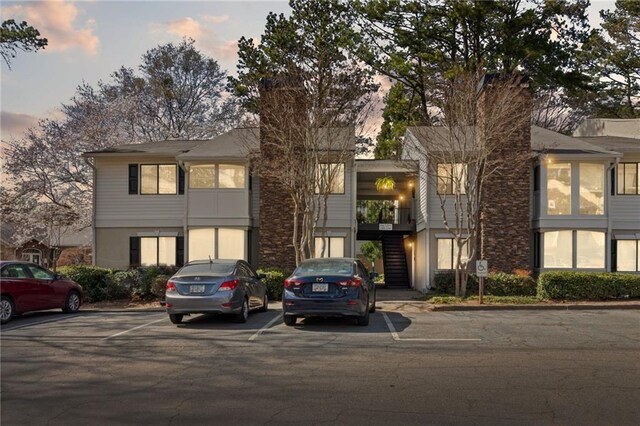 view of building exterior with a residential view and uncovered parking