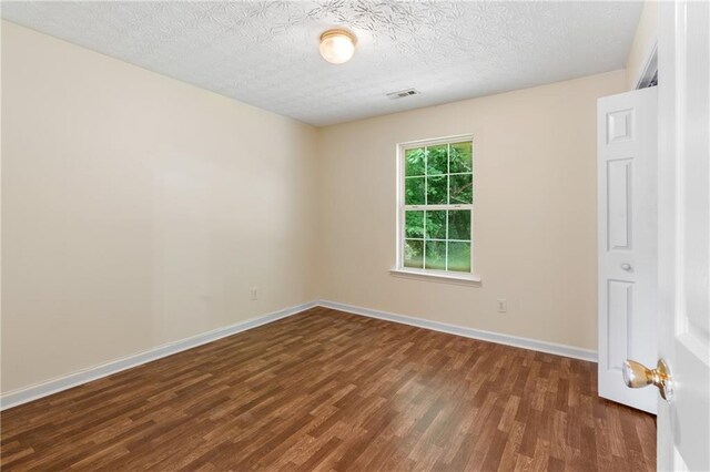 131 Tye St, Stockbridge, GA 30281 - spare room with wood finished floors, baseboards, and a textured ceiling