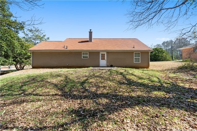 131 Tye St, Stockbridge, GA 30281 - rear view of property featuring a yard and a chimney
