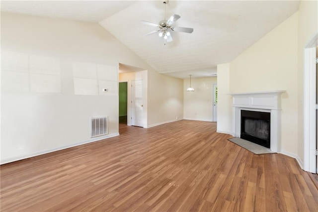 131 Tye St, Stockbridge, GA 30281 - unfurnished living room with a fireplace with flush hearth, light wood-style floors, ceiling fan, baseboards, and high vaulted ceiling