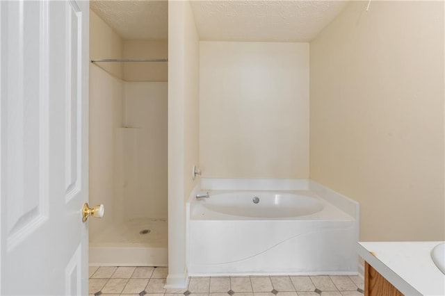 131 Tye St, Stockbridge, GA 30281 - full bathroom featuring vanity, tile patterned flooring, a bath, a shower, and a textured ceiling