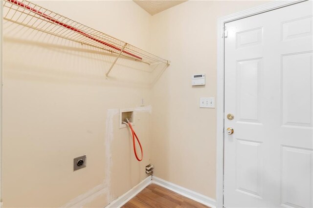 131 Tye St, Stockbridge, GA 30281 - washroom with electric dryer hookup, baseboards, light wood-type flooring, and washer hookup