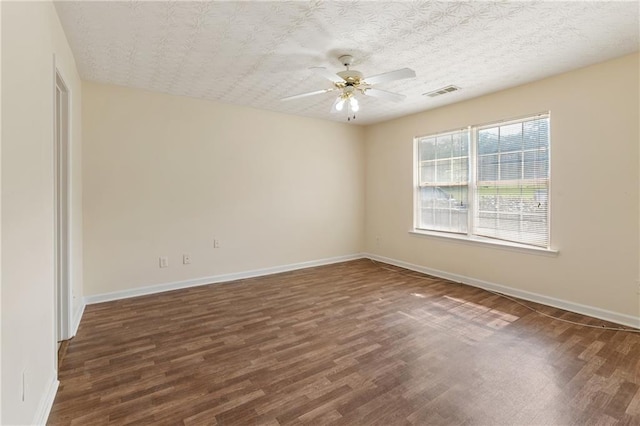131 Tye St, Stockbridge, GA 30281 - empty room with dark wood-type flooring, a ceiling fan, and baseboards