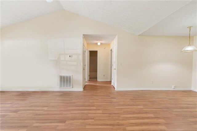 131 Tye St, Stockbridge, GA 30281 - spare room featuring light wood-type flooring, vaulted ceiling, and baseboards