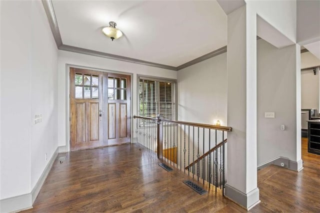 entryway featuring dark hardwood / wood-style floors and crown molding