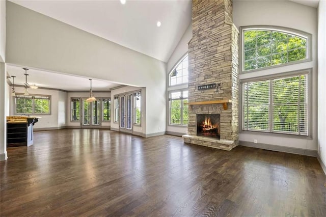 unfurnished living room with ceiling fan, dark hardwood / wood-style flooring, a fireplace, and high vaulted ceiling