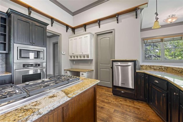 kitchen with light stone countertops, ornamental molding, stainless steel appliances, pendant lighting, and dark hardwood / wood-style floors