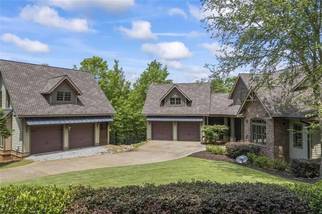 view of front of house featuring a front yard and a garage