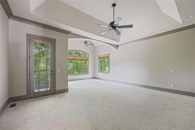 unfurnished room with ceiling fan, carpet floors, crown molding, and lofted ceiling