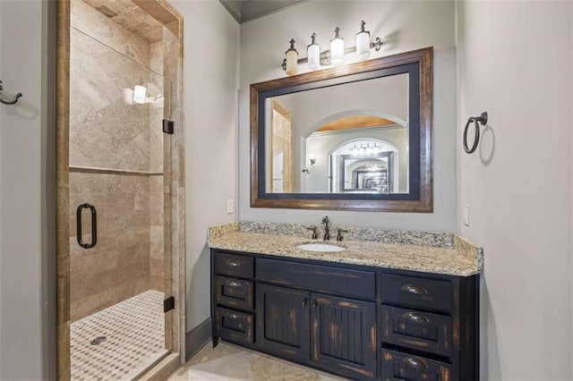 bathroom featuring tile patterned floors, a shower with door, and vanity