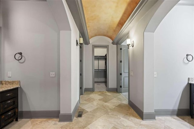 bathroom featuring vanity, lofted ceiling, and brick ceiling