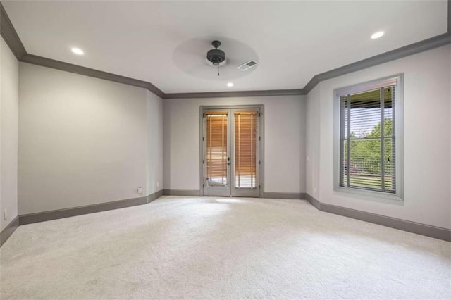 unfurnished room featuring light carpet, ceiling fan, and ornamental molding