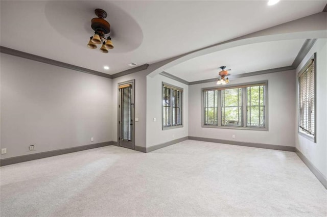 spare room with ceiling fan, ornamental molding, and light carpet