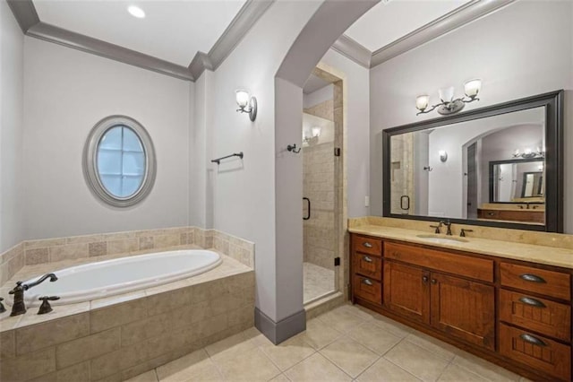 bathroom featuring tile patterned floors, crown molding, vanity, and independent shower and bath