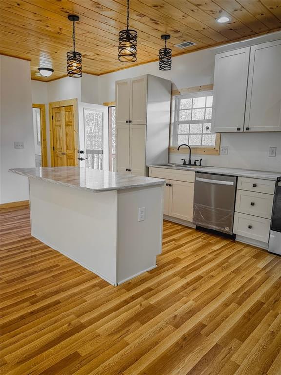 kitchen featuring a center island, light hardwood / wood-style floors, wood ceiling, and stainless steel dishwasher