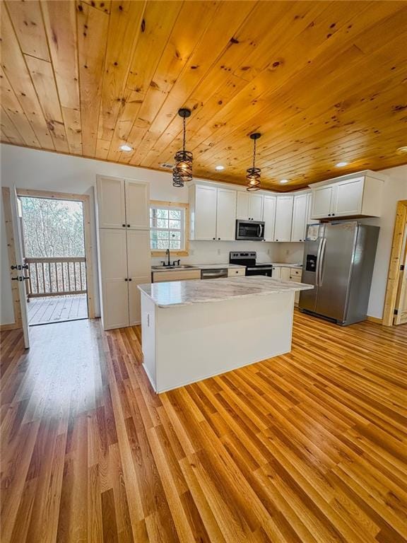 kitchen featuring wooden ceiling, ceiling fan, and stainless steel appliances