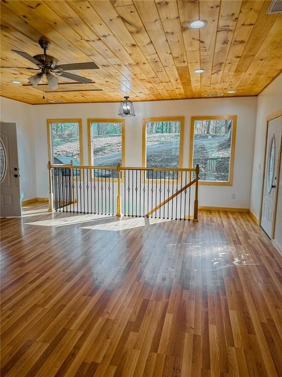 unfurnished room featuring wood ceiling, ceiling fan, and hardwood / wood-style flooring