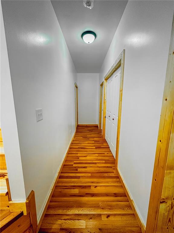 hallway featuring hardwood / wood-style flooring