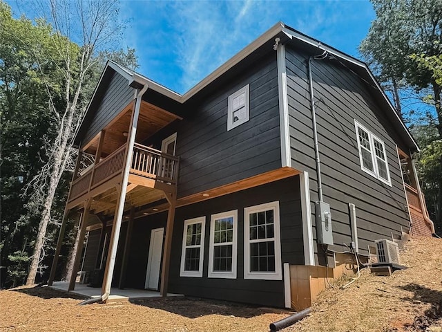 back of property with a balcony