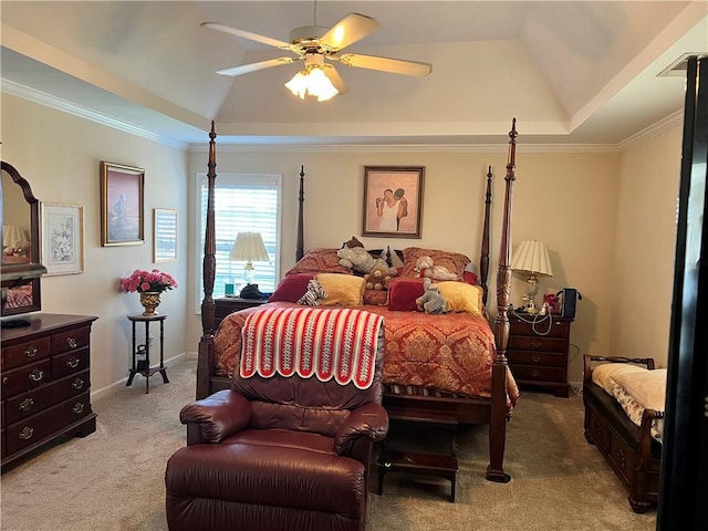 bedroom featuring a tray ceiling, ceiling fan, crown molding, and light colored carpet