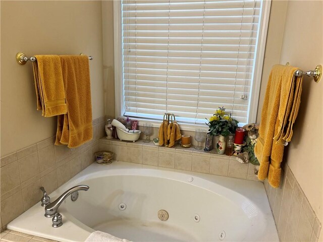 bathroom with a relaxing tiled tub