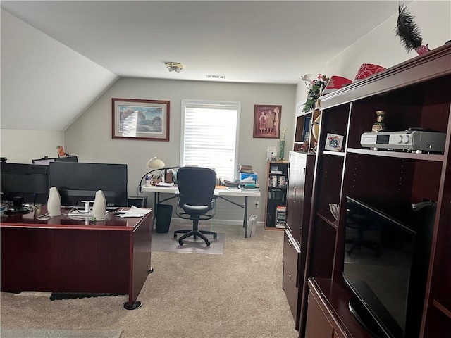 carpeted office featuring lofted ceiling