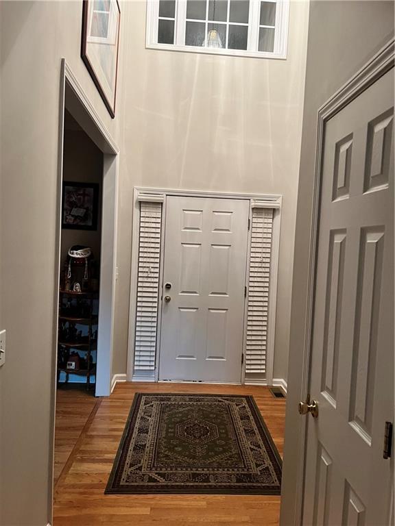 bedroom with light colored carpet and multiple windows