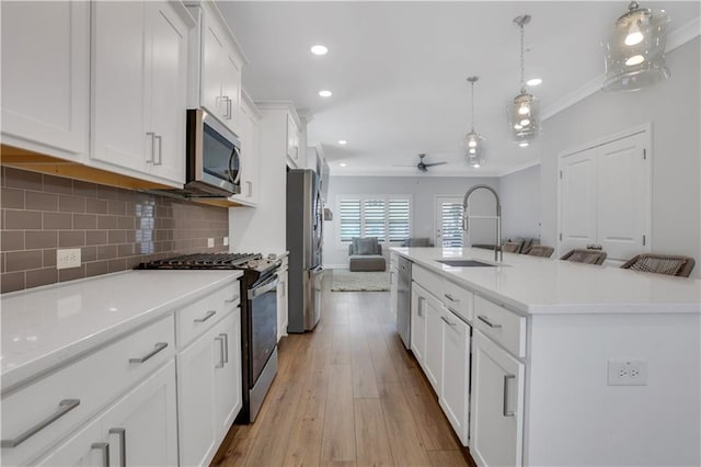 1768 Evenstad Way, Smyrna, GA 30080 - kitchen with appliances with stainless steel finishes, a sink, open floor plan, a ceiling fan, and white cabinetry