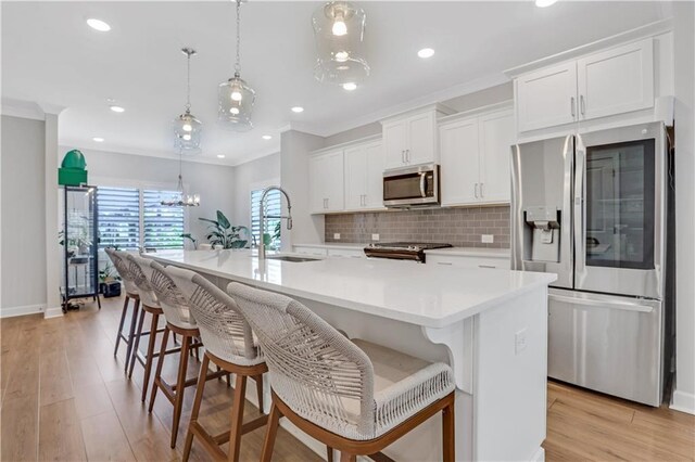 1768 Evenstad Way, Smyrna, GA 30080 - kitchen with appliances with stainless steel finishes, a sink, white cabinetry, tasteful backsplash, and a center island with sink