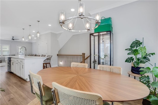 1768 Evenstad Way, Smyrna, GA 30080 - dining space featuring a ceiling fan, a chandelier, recessed lighting, crown molding, and light wood finished floors