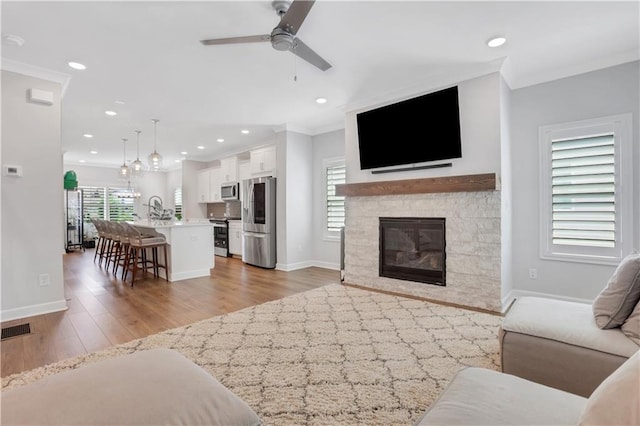 1768 Evenstad Way, Smyrna, GA 30080 - living area featuring a ceiling fan, ornamental molding, recessed lighting, baseboards, and light wood-style flooring