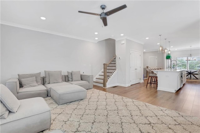 1768 Evenstad Way, Smyrna, GA 30080 - living area with wood finished floors, a ceiling fan, ornamental molding, recessed lighting, and a chandelier