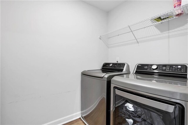 1768 Evenstad Way, Smyrna, GA 30080 - laundry room featuring separate washer and dryer, wood finished floors, and baseboards