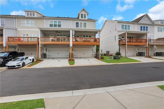 1768 Evenstad Way, Smyrna, GA 30080 - townhome / multi-family property featuring an attached garage, driveway, central air condition unit, and board and batten siding