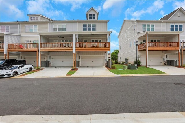 1768 Evenstad Way, Smyrna, GA 30080 - townhome / multi-family property featuring an attached garage, driveway, board and batten siding, and central air condition unit