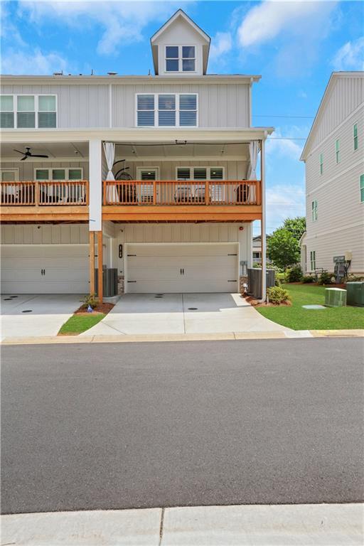 1768 Evenstad Way, Smyrna, GA 30080 - view of front of home with a garage, driveway, central air condition unit, and board and batten siding