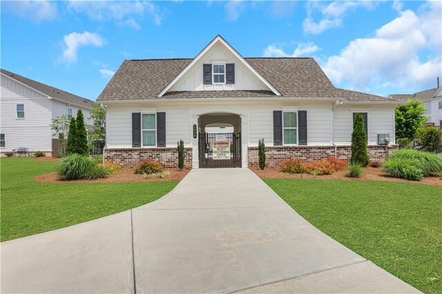 1768 Evenstad Way, Smyrna, GA 30080 - view of front of home featuring brick siding, a front yard, concrete driveway, and a gate